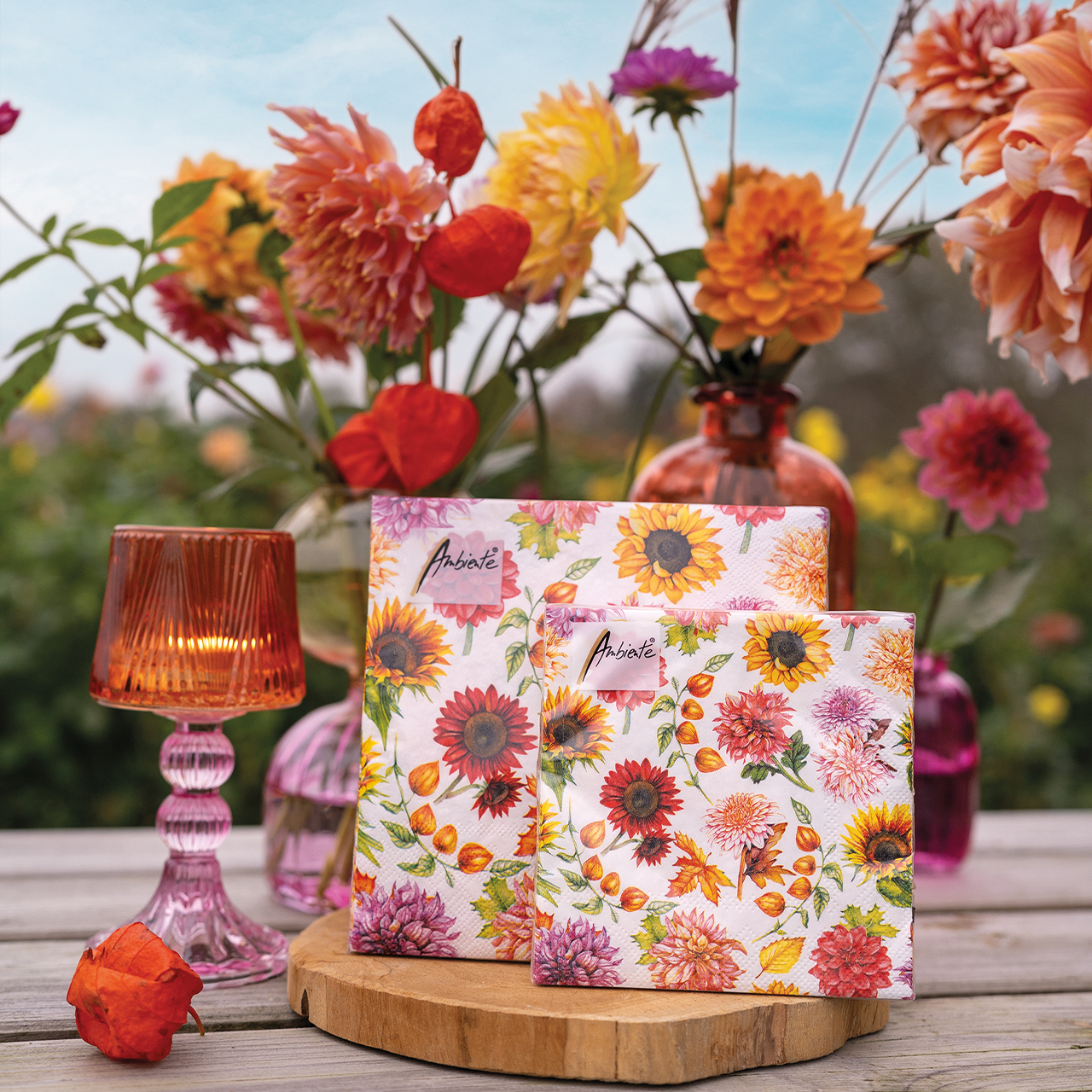2 sizes FSC paper napkins Autumn blooming with colourful floral print, outdoor setting with candle and flowers